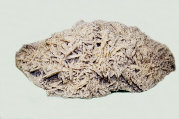 Stilbit, a pseudomorphosis of white on a light background. Gems, mineralogy, jewelry.