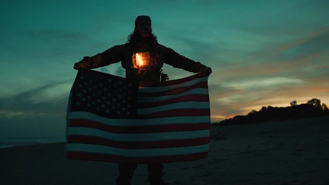 American flag Memorial wrapped around a soldier in silhouette at sunset night
