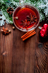 cup with christmas mulled wine on wooden background top view