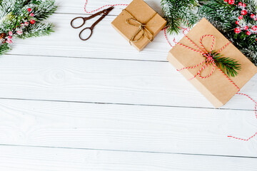 gifts boxes with fir branches on wooden background top view