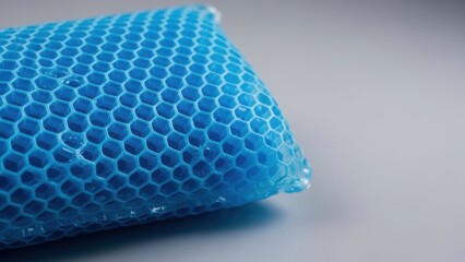 Close-up of a blue gel honeycomb cushion texture. Flexible cooling mat with hexagonal pattern. Copy space for text