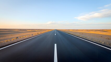 Fototapeta premium Open Road Stretching Through Desert Landscape Under Clear Sky