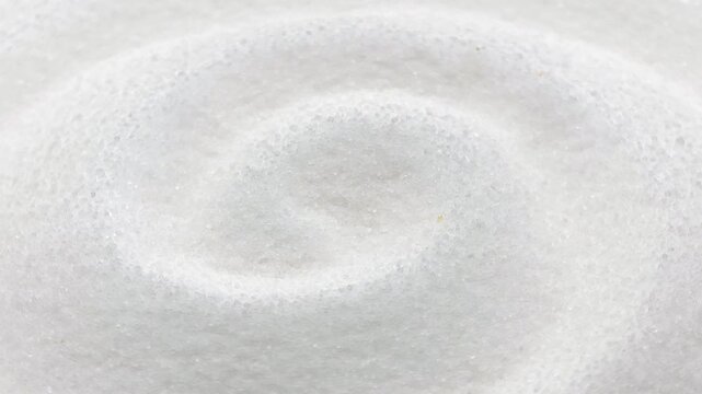 Macro shot of white sea salt crystals in swirl pattern