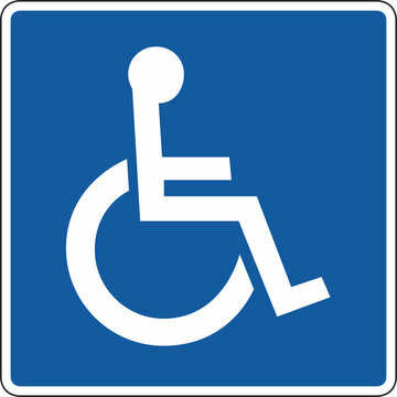 A blue and white handicap parking sign with a wheelchair symbol