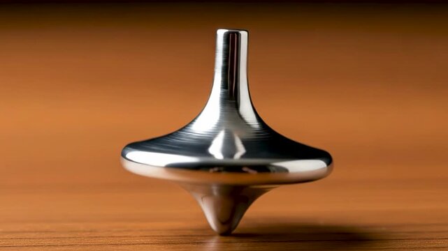 Silver metal spinning top rotating on wooden desk, inception totem reality check, physics balance concept, executive stress relief toy, seamless loop motion background