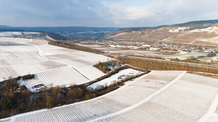 Moselle valley, winter season, snow and frost covered vineyard and river landscape near Trier, Germany, aerial view