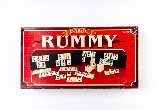 Valmiera, Latvia - December 09, 2025: Classic Rummy board game box featuring colorful tiles and cards displayed on a white background with copy space