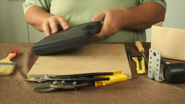 A man checks work tools at his workplace.