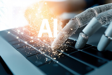 Robotic hand types near glowing AI letters above laptop keys.