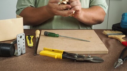 A man checks work tools at his workplace.
