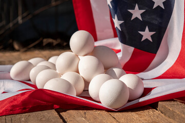 Chicken eggs with the US flag in the background. Countryside outdoor setting