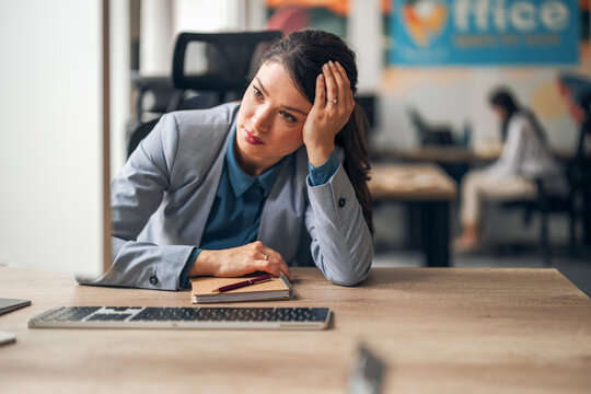 Businesswoman experiencing burnout and emotional exhaustion at corporate office