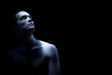 Male neck and shoulders portrait in dramatic studio light. Concept of skin texture presentation, dermatology education assets, cosmetic treatment visuals, and clinic marketing materials.