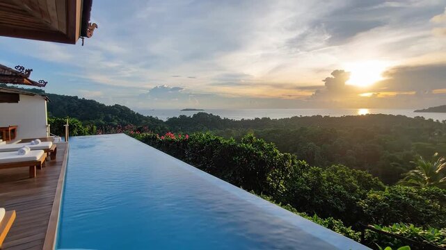 Luxury infinity pool overlooking a tropical forest and ocean at sunset, creating a serene escape.