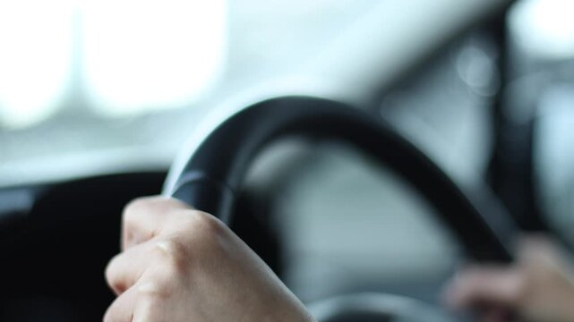 Hand holding steering wheel while driving condition