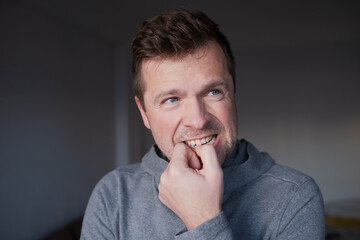 Worried male person having a bad habit, concept of mental health problems or business failure.