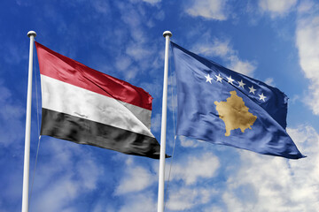 Waving flags of the Yemen and Kosovo together on blue sky background. Official diplomatic relations, partnership and business concept.
