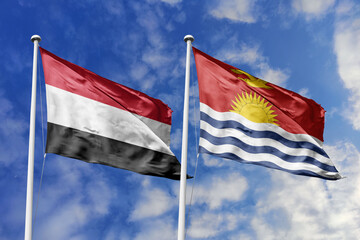 Waving flags of the Yemen and Kiribati together on blue sky background. Official diplomatic relations, partnership and business concept.