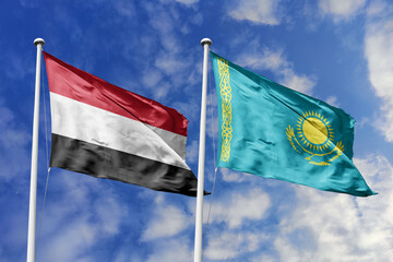 Waving flags of the Yemen and Kazakhstan together on blue sky background. Official diplomatic relations, partnership and business concept.