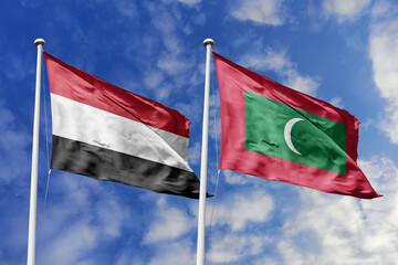 Waving flags of the Yemen and Maldives together on blue sky background. Official diplomatic relations, partnership and business concept.