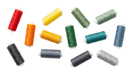 Colorful Spools of Thread Scattered on White Background