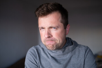 Suspicious male person looking with disbelief, doubt and judgment.