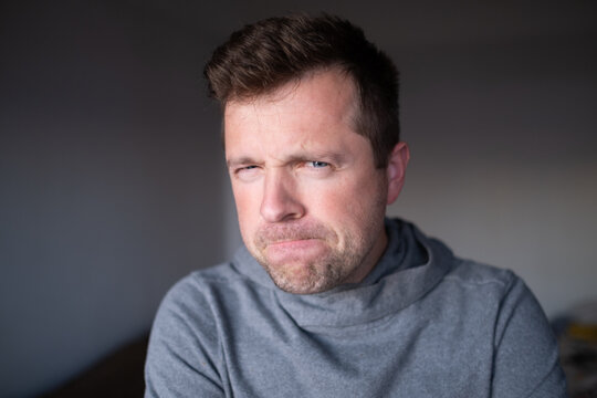 Suspicious male person looking with disbelief, doubt and judgment.
