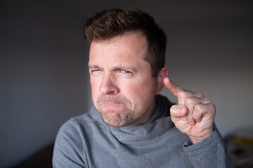 Suspicious male person looking with disbelief, doubt and judgment.