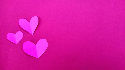 Pink and Red Paper Hearts on Pastel Purple Background for Romantic Valentine Concept