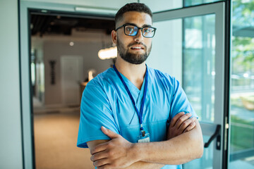 Confident young adult male nurse in hospital