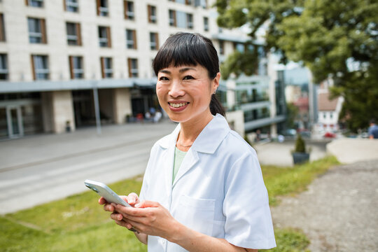 Smiling professional woman with smartphone