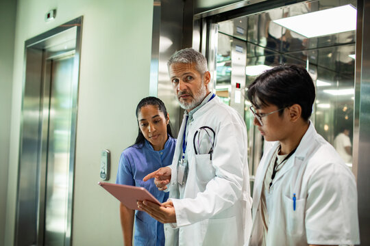 Medical team discussing in hospital hallway