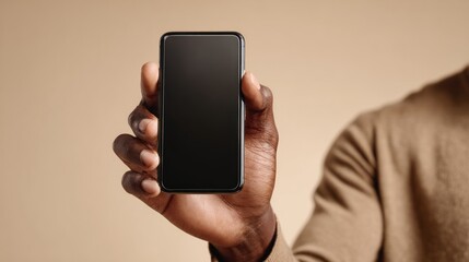 Close-up of a person holding a smartphone with a blank screen, ideal for app display or mobile technology concepts.