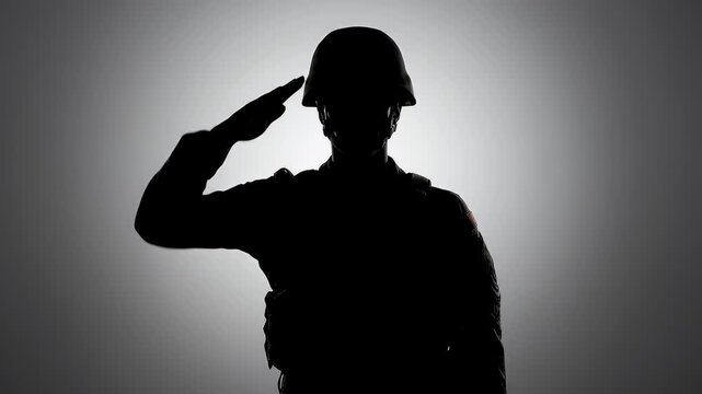 Silhouette of soldier saluting on veterans day, studio shot.