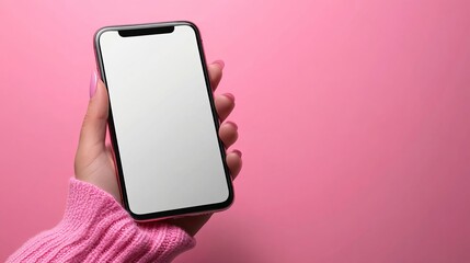 Woman s Hand Holding a Smartphone Against a Bright Pink Background Displaying a Blank Screen