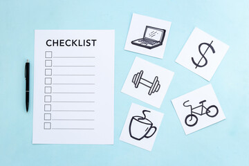 Checklist and many paper cards with hand drawing of different life activities, top view. Life balance and planning concept.