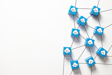 Blue wooden blocks with cloud folder icons connected by lines. Concept of cloud computing network, data storage server,digital system architecture,internet hosting technology on white background.