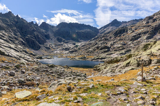Laguna Grande de Gredos in Sierra de Gredos, landscape with high rocky mountains in the background, autumn view, Spain.