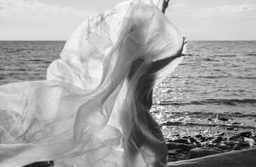 nude woman on nature background under plastic wrap