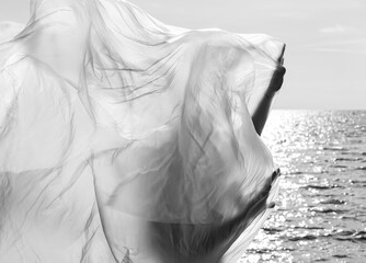 nude woman on nature background under plastic wrap