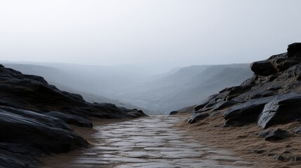 Obraz premium Dense Fog Rolls into an Abandoned Rocky Path Captured in a Mysterious Landscape Scene