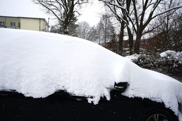Black car covered in snow