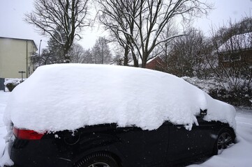 Black car covered in snow