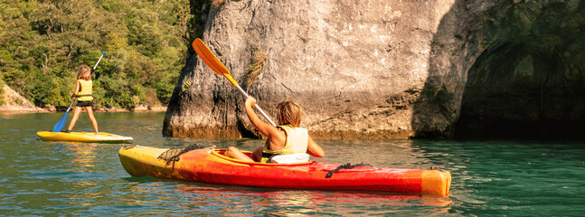 children enjoying their vacation, canoe, paddle in the river, family recreation leisure