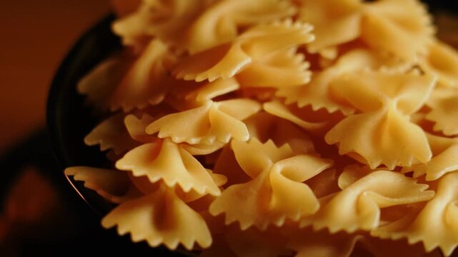 Fresh farfalle pasta in a bowl ready for cooking at a kitchen table