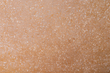 オレンジ色の石材テクスチャと大理石の破片が混ざり合う背景素材
