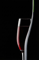 Elegant red wine glass with minimalist white silhouette on black background