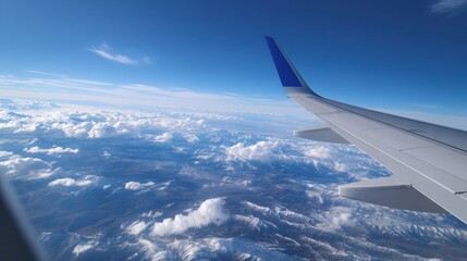Fototapeta premium High Altitude Flight Over Mountains with Contrails and Vast Sky View