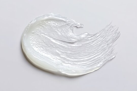 Hydrating Vaseline Application. Dollop of creamy skin care product. Glossy balm texture. Petroleum jelly ointment swatch. Swoosh swatch sample cosmetics. Facial jelly, cleanser. Drop isolate on white.