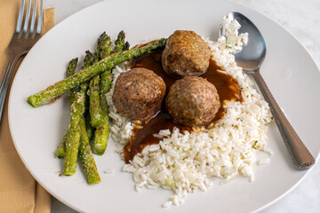  meatballs on rice and gravy with roasted asparagus
